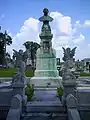 Marble bust of Mark Winner, flanked by two marble angels