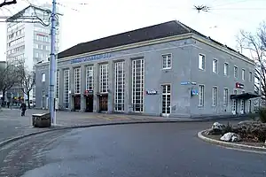 Two-story building with floor-to-ceiling windows and hip roof