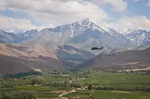 Black Hawk flying over a valley in Bamyan