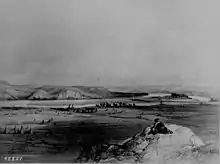 Lithograph giving an overview of a river valley and Fort Pierre Chouteau, surrounded by tipis.