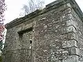 The viewing window from the outside showing the later iron balustrade.