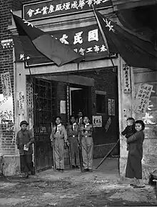 Boy Scouts standing in front the door of a polling office in Shanghai