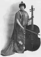 Middle-aged white woman holding a cello