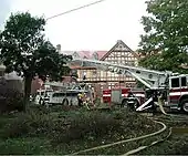 The lodge burning and firetrucks parked outside