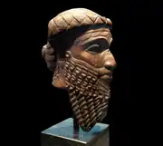 A bronze head artefact, with the beard depicted prominently. The artefact is believed to illustrate the Akkadian god-king Naram-Sin, or his grandfather Sargon of Akkad.