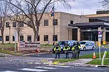 Police officers standing outside the Brooklyn Center police station following the shooting