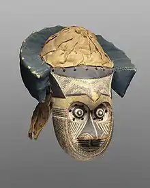 Pwoom Itok mask; late 19th century; 39.1 x 28.6 x 29.8 cm (153⁄8 x 111⁄4 x 113⁄4 in.); Brooklyn Museum (USA). This mask may have represented a wise older man at boys' initiations. One of the principal Kuba dance masks is called pwoom itok. The chief identifying characteristic is the shape of the eyes, whose centers are cones surrounded by holes through which the wearer sees