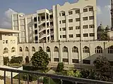 Building B, which houses three two-floor lecture halls for students in the first three years, in addition to examination halls. The minarets in the background are those of Al Nour Mosque.