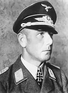 A man wearing a military uniform with an Iron Cross displayed at the front of his uniform collar.