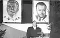 German writer Louis Fürnberg giving a speech in front of the portraits of Klement Gottwald and Joseph Stalin