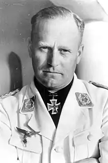 Black-and-white portrait of a man wearing a military uniform with an Iron Cross displayed at his neck.