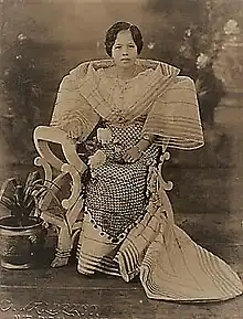 Woman in terno with stiffened "butterfly" sleeves