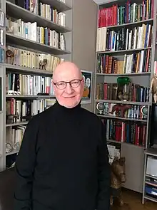 Mercier smiling with book in the background