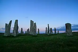 A number of tall stone monuments in a field