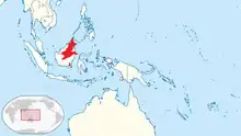 Map of Indonesia, with red shading indicating the species inhabits northern, central, and extreme southeastern Borneo