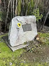 Memorial stone with flower and plaque