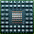 The underside of the 90 nm Cell/B.E. processor showing its 1242 solder balls, each 0.6 mm in diameter, and its array of 35 capacitors.