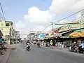 On National Highway 61, the section passing Cái Tắc town market.