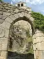 Gateway on the ramp leading from the village to the castle. Above, the bell-gable of the chapel.