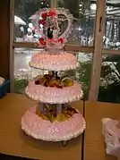 A wedding cake topped with a wedding cake topper