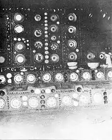 An interior photograph of a chi shrine with plates inset into the polished mud walls