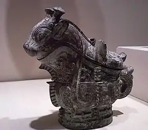 Ritual wine server (guang); 1100 BC; 21 × 22.9 cm (8.25 × 9 in); Indianapolis Museum of Art. Adorning the surface of the vessel are three primary decorative animal motifs, including fifteen imaginary creatures cast in relief along the sides