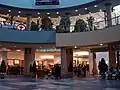 The centre court and food court of Chinook Centre before renovations from the lower level on July 23, 2006, showing Club Monaco, Yogen Fruz, and an HMV (closed) poster.