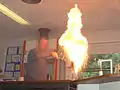 Pouring a very small amount of water into the fire ejects a plume of fire...