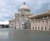 domed stone building alongside a canal or river