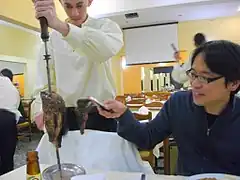 Waiter serves rodízio style in Japan