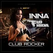 Shot of Inna wearing a black–white bra in front of a car. Information about the song is superimposed on her right.