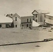 Disheveled and uneven houses atop a layer of sand