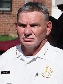 A picture of Worley in police uniform during a speech in 2023