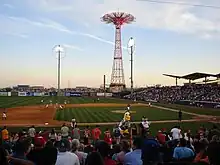 The baseball field inside the Maimonides Park baseball stadium. The Parachute Jump is behind the stadium.