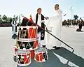 During a military-religious flag Consecration ceremony, Canadian Forces chaplains bless the Royal Military College of Canada Colours, which lean on top of a stack of College drums on a platform