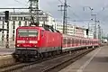 A DB Class 143 with x-Wagen coaches leaves Hauptbahnhof