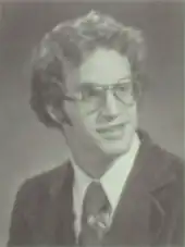 Portrait of teenage man with glasses wearing a suit