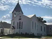 Old plain white church with tower