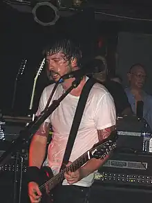 Dave Grohl sings and plays the guitar atop a stage.