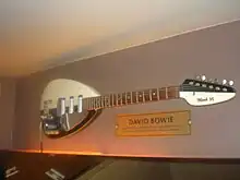 A guitar hanging on a wall