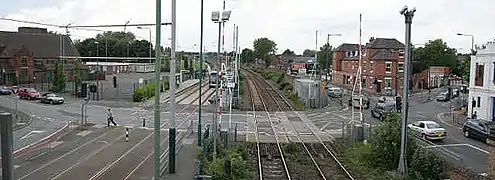 The level crossings seen from above; a tram is in the tram stop.