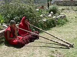 Monks playing dungchen, Dechen Phodrang monastic school, Thimphu