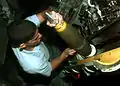 USS John Young's sailor loads a projectile into her 5-inch gun on 9 February 1998