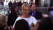 Dianna Agron at a film premiere, smiling at fans.