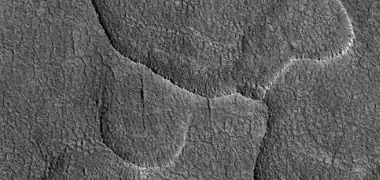 Close-up of scalloped ground, as seen by HiRISE under HiWish program.  Surface is divided into polygons; these forms are common where ground freezes and thaws.  Note: this is an enlargement of a previous image.