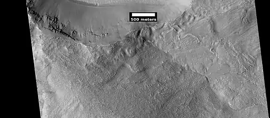 Smooth mantle covers parts of a crater in the Phaethontis quadrangle. Layering suggests the mantle was deposited multiple times.