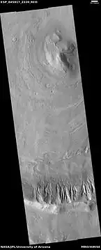 Wide view of dipping layers in Ismenius Lacus quadrangle, as seen by HiRISE under HiWish program Gullies are also visible at the bottom of the image.