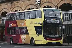 An EastRider-branded yellow and red double-decker bus at York railway station