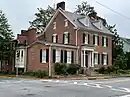 two and a half story brick building with wing