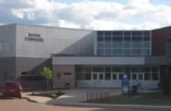 A two-storey school made of stone and lots of windows